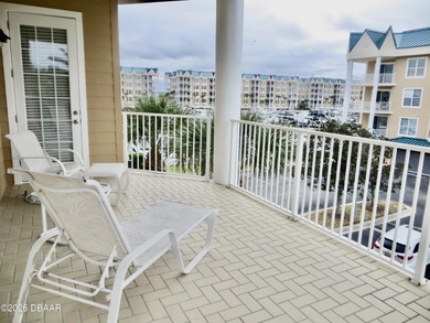 Bright open plan corner unit has TWO balconies overlooking woods on Harbour Village Golf and Yacht Club in Florida - for sale on GolfHomes.com, golf home, golf lot