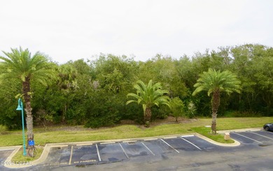 Bright open plan corner unit has TWO balconies overlooking woods on Harbour Village Golf and Yacht Club in Florida - for sale on GolfHomes.com, golf home, golf lot