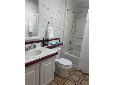 So much to love in this beautifully furnished 3-bed, 2-bath home on Sabal Springs Golf and Racquet Club in Florida - for sale on GolfHomes.com, golf home, golf lot