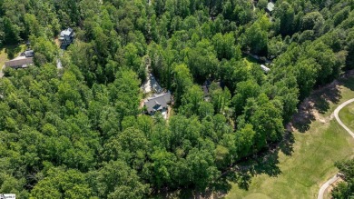 Tucked beside a quiet creek and backing up to The Rock Golf Club on The Rock At Jocassee in South Carolina - for sale on GolfHomes.com, golf home, golf lot
