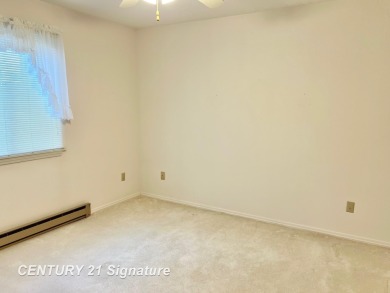 Enjoy easy living in this 2-bedroom, 2-full-bath condo perfectly on Swan Valley Golf Club in Michigan - for sale on GolfHomes.com, golf home, golf lot