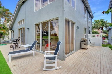 Golf course views fill this charming 2-story home of 4 bedrooms on Woodfield Country Club in Florida - for sale on GolfHomes.com, golf home, golf lot