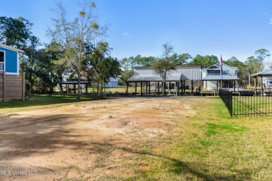 Enjoy this beautiful waterfront lot while planning your dream on Pass Christian Isles Golf Club in Mississippi - for sale on GolfHomes.com, golf home, golf lot
