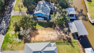 Enjoy this beautiful waterfront lot while planning your dream on Pass Christian Isles Golf Club in Mississippi - for sale on GolfHomes.com, golf home, golf lot
