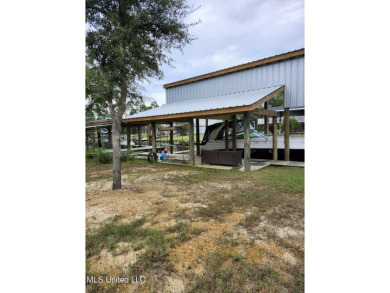 Enjoy this beautiful waterfront lot while planning your dream on Pass Christian Isles Golf Club in Mississippi - for sale on GolfHomes.com, golf home, golf lot