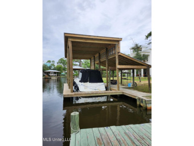 Enjoy this beautiful waterfront lot while planning your dream on Pass Christian Isles Golf Club in Mississippi - for sale on GolfHomes.com, golf home, golf lot