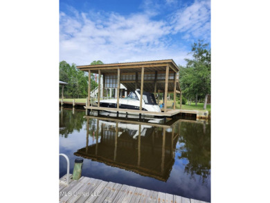 Enjoy this beautiful waterfront lot while planning your dream on Pass Christian Isles Golf Club in Mississippi - for sale on GolfHomes.com, golf home, golf lot
