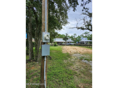 Enjoy this beautiful waterfront lot while planning your dream on Pass Christian Isles Golf Club in Mississippi - for sale on GolfHomes.com, golf home, golf lot