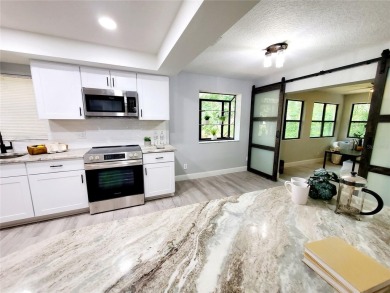 ** TOTAL REMODEL 2024!** Enjoy maintenance-free living with a on Tarpon Woods Golf Club in Florida - for sale on GolfHomes.com, golf home, golf lot