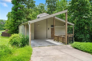 Tucked into the trees just minutes from Bentonville, this on Bella Vista - Metfield Golf Complex and Country Club in Arkansas - for sale on GolfHomes.com, golf home, golf lot