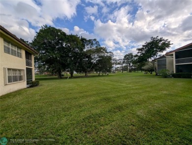 Just Reduced! This beautifully renovated 3-bedroom, 2-bathroom on Woodmont Country Club in Florida - for sale on GolfHomes.com, golf home, golf lot