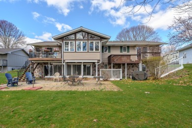 This fantastic home overlooks the 14th green of Lake Cora Hills on Lake Cora Hills Golf Club in Michigan - for sale on GolfHomes.com, golf home, golf lot