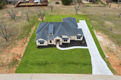 Built by Matteson Homes, this new construction home offers on Pecan Plantation Country Club in Texas - for sale on GolfHomes.com, golf home, golf lot