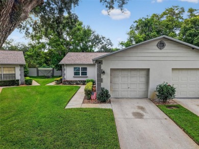 Discover low-maintenance Florida living in this beautifully on Seven Springs Golf and Country Club in Florida - for sale on GolfHomes.com, golf home, golf lot