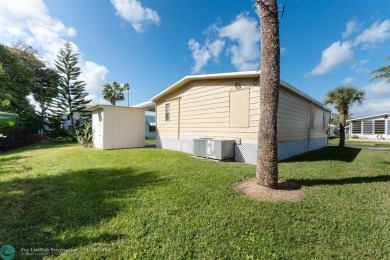 Step into this beautifully maintained 2-bedroom, 2-bath mobile on Vero Beach Country Club in Florida - for sale on GolfHomes.com, golf home, golf lot