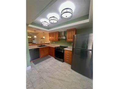 Welcome to this stunning 2-bedroom, 2-bathroom first-floor condo on East Lake Woodlands Country Club in Florida - for sale on GolfHomes.com, golf home, golf lot