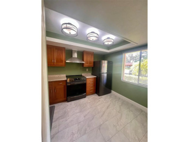 Welcome to this stunning 2-bedroom, 2-bathroom first-floor condo on East Lake Woodlands Country Club in Florida - for sale on GolfHomes.com, golf home, golf lot