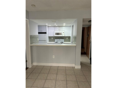 This  a   2 bedroom  2 bath condo  unit located on the  first on Country Club of Miami in Florida - for sale on GolfHomes.com, golf home, golf lot