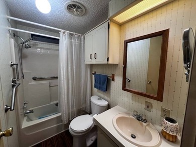 This 2-bedroom, 2-bath home offers 1,296 sq ft of comfortable on Lake Henry Golf Club in Florida - for sale on GolfHomes.com, golf home, golf lot