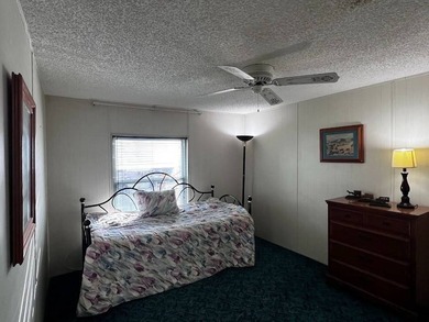 This 2-bedroom, 2-bath home offers 1,296 sq ft of comfortable on Lake Henry Golf Club in Florida - for sale on GolfHomes.com, golf home, golf lot