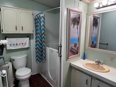 This 2-bedroom, 2-bath home offers 1,296 sq ft of comfortable on Lake Henry Golf Club in Florida - for sale on GolfHomes.com, golf home, golf lot