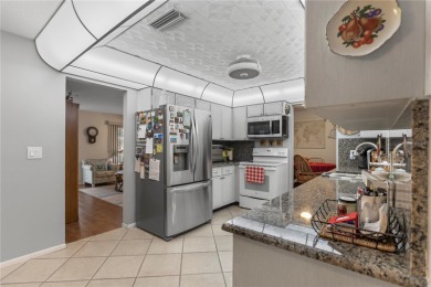 Welcome to this beautifully maintained 2-bedroom, 2-bath home on Mainlands Golf Club in Florida - for sale on GolfHomes.com, golf home, golf lot