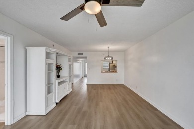 Experience resort-style living in this spacious 2-bedroom on Pine Island Ridge Country Club in Florida - for sale on GolfHomes.com, golf home, golf lot