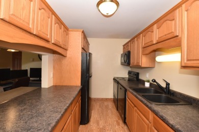 Enjoy open-concept living in this modern upper-level condo on BlackStone Creek Golf Club in Wisconsin - for sale on GolfHomes.com, golf home, golf lot
