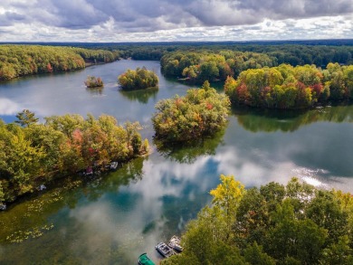 Escape to the serene beauty of Lake of the Clouds with this on Canadian Lakes Country Club-The Highlands Course in Michigan - for sale on GolfHomes.com, golf home, golf lot