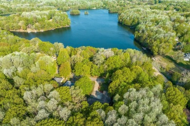 Escape to the serene beauty of Lake of the Clouds with this on Canadian Lakes Country Club-The Highlands Course in Michigan - for sale on GolfHomes.com, golf home, golf lot
