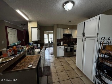 Nestled on two spacious lots, this charming 3-bedroom, 2-bath on The Kings Arrow Ranch in Mississippi - for sale on GolfHomes.com, golf home, golf lot