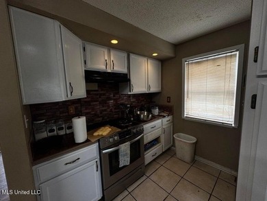 Nestled on two spacious lots, this charming 3-bedroom, 2-bath on The Kings Arrow Ranch in Mississippi - for sale on GolfHomes.com, golf home, golf lot