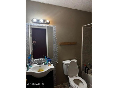 Nestled on two spacious lots, this charming 3-bedroom, 2-bath on The Kings Arrow Ranch in Mississippi - for sale on GolfHomes.com, golf home, golf lot