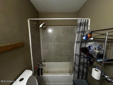 Nestled on two spacious lots, this charming 3-bedroom, 2-bath on The Kings Arrow Ranch in Mississippi - for sale on GolfHomes.com, golf home, golf lot