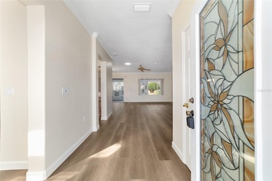 Welcome home and step into this popular Sanibel model on Eagle Ridge At Spruce Creek Country Club in Florida - for sale on GolfHomes.com, golf home, golf lot