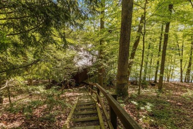 Charming Lakefront Cabin tucked away in the woods overlooking on Hide-A-Way Hills Golf Club in Ohio - for sale on GolfHomes.com, golf home, golf lot