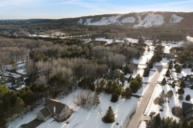 Experience the essence of Northern Michigan living with this on Boyne Highlands Golf Courses in Michigan - for sale on GolfHomes.com, golf home, golf lot