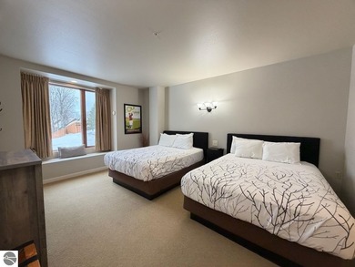 Enjoy views of the 18th hole and pond at the Lodge at Cedar on Schuss Mountain Golf Club in Michigan - for sale on GolfHomes.com, golf home, golf lot