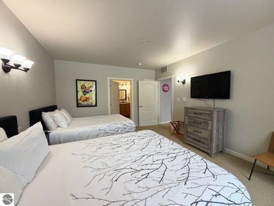 Enjoy views of the 18th hole and pond at the Lodge at Cedar on Schuss Mountain Golf Club in Michigan - for sale on GolfHomes.com, golf home, golf lot