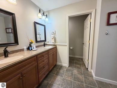 Enjoy views of the 18th hole and pond at the Lodge at Cedar on Schuss Mountain Golf Club in Michigan - for sale on GolfHomes.com, golf home, golf lot