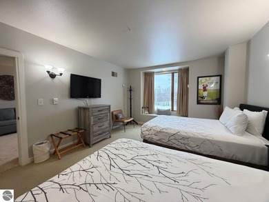 Enjoy views of the 18th hole and pond at the Lodge at Cedar on Schuss Mountain Golf Club in Michigan - for sale on GolfHomes.com, golf home, golf lot