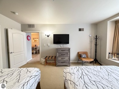 Enjoy views of the 18th hole and pond at the Lodge at Cedar on Schuss Mountain Golf Club in Michigan - for sale on GolfHomes.com, golf home, golf lot