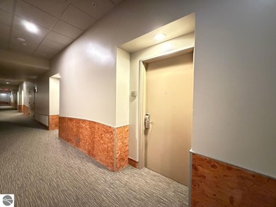 Enjoy views of the 18th hole and pond at the Lodge at Cedar on Schuss Mountain Golf Club in Michigan - for sale on GolfHomes.com, golf home, golf lot