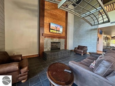 Enjoy views of the 18th hole and pond at the Lodge at Cedar on Schuss Mountain Golf Club in Michigan - for sale on GolfHomes.com, golf home, golf lot