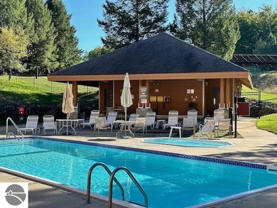 Enjoy views of the 18th hole and pond at the Lodge at Cedar on Schuss Mountain Golf Club in Michigan - for sale on GolfHomes.com, golf home, golf lot