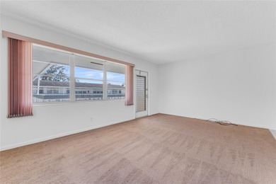 Enjoy peaceful living in this spacious 1-bedroom, 1.5-bath on Hillsboro Pines Golf in Florida - for sale on GolfHomes.com, golf home, golf lot