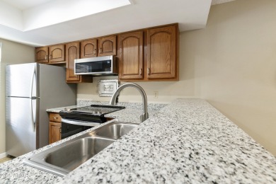 Step into this beautifully updated, move-in-ready end unit in on Fountain of the Sun Country Club in Arizona - for sale on GolfHomes.com, golf home, golf lot