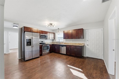 This beautifully maintained three-bedroom, two-bath home with a on The Dunedin Country Club in Florida - for sale on GolfHomes.com, golf home, golf lot