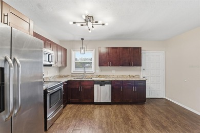 This beautifully maintained three-bedroom, two-bath home with a on The Dunedin Country Club in Florida - for sale on GolfHomes.com, golf home, golf lot