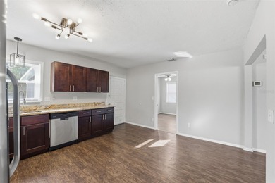 This beautifully maintained three-bedroom, two-bath home with a on The Dunedin Country Club in Florida - for sale on GolfHomes.com, golf home, golf lot